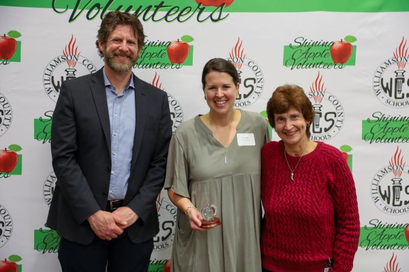 A man and two women pose for a photo